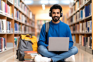 Student on the floor surrounded by notebooks, headphones, coffee, a School & Education Photo by DanFLCreativo
