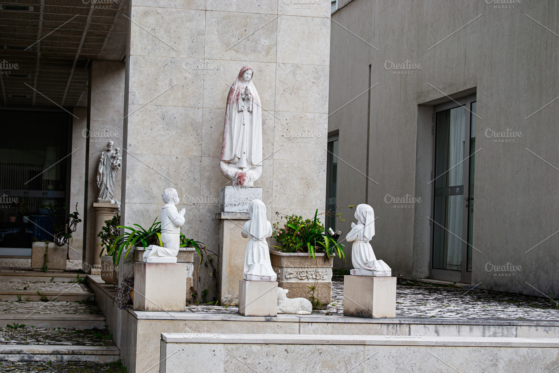 Religious statues depicting Fatima scene outside a holy building in Portugal, a Photo by AS photostudio