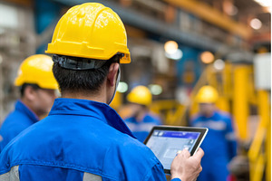 Two workers are seen wearing hard, an Industrial Photo by ZinetroN