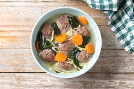 Italian Wedding Soup with meatballs and spinach on wooden table, a Food & Drink Photo by etorres69