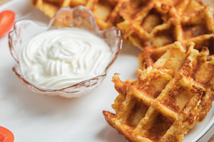 Top view of Homemade Potato Waffles, ricotta cheese and mayonese sauce. Served, a Food & Drink Photo by Budarinphoto