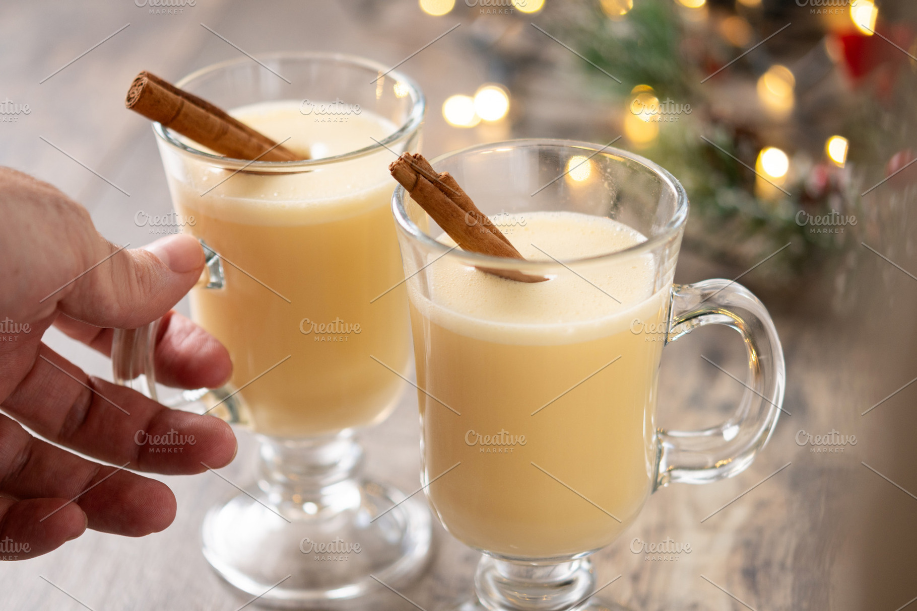 Hand picking up a glass of eggnog from a Christmas table, a Food & Drink Photo by etorres69