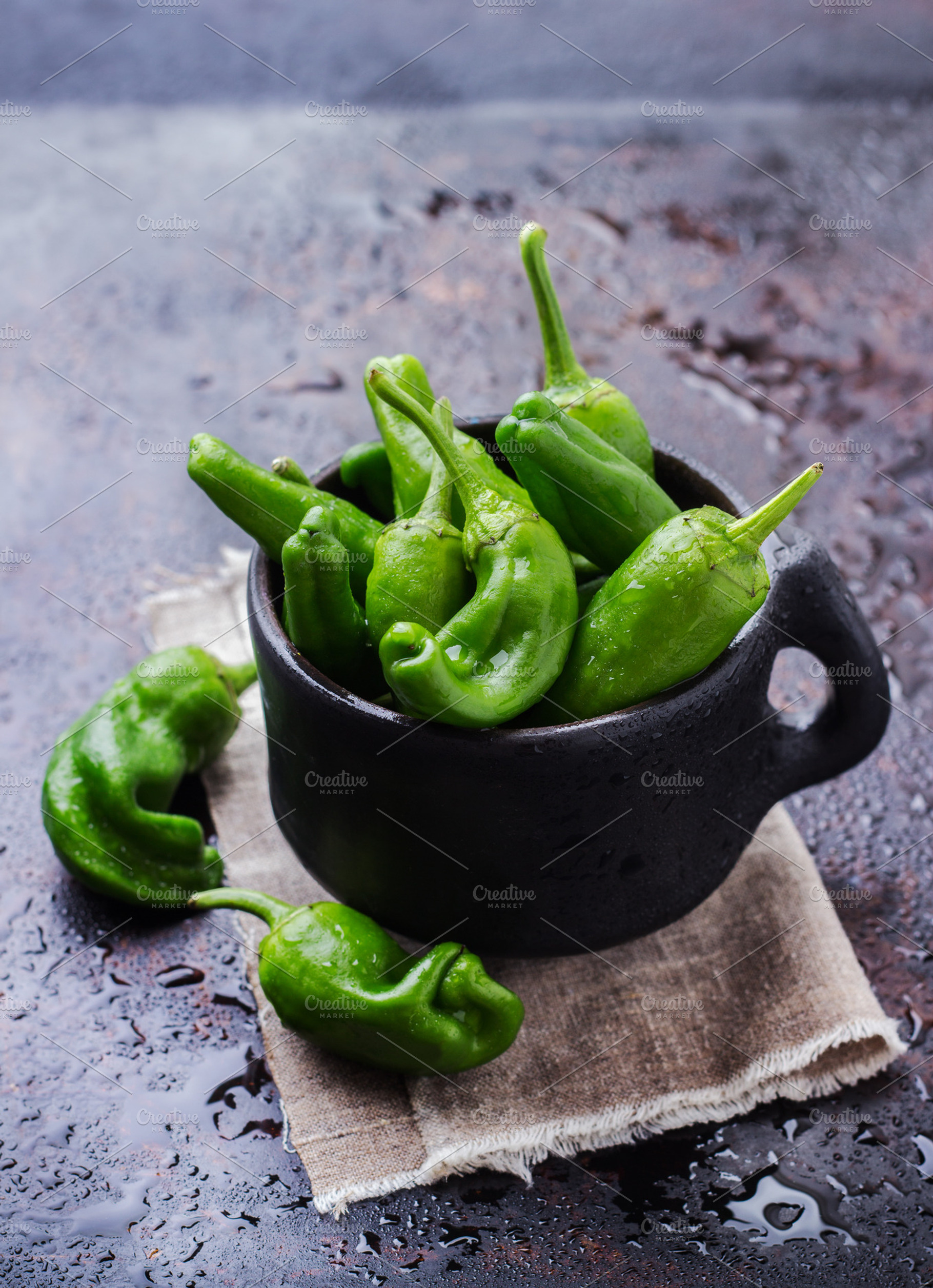 Raw green peppers pimientos de padron traditional spanish tapas featuring, a Food & Drink Photo by Antonina Vlasova