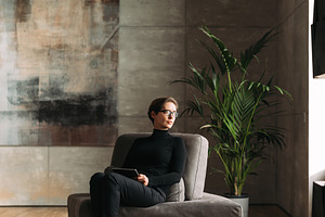 Middle-aged woman in black wear, a Person Photo by Artem Varnitsin