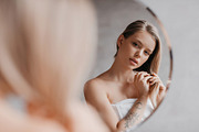 Natural beauty. Pretty young lady touching her soft hair, standing near mirror, a Photo by Prostock-Studio (Thumbnail 3 of 3)