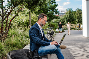 Manager working in urban park, a Business Photo by HalfPoint