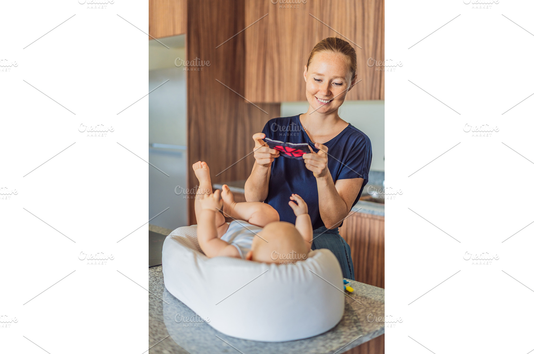 Mother talking to baby lying in cozy, a Food & Drink Photo by Elizaveta Galitskaya
