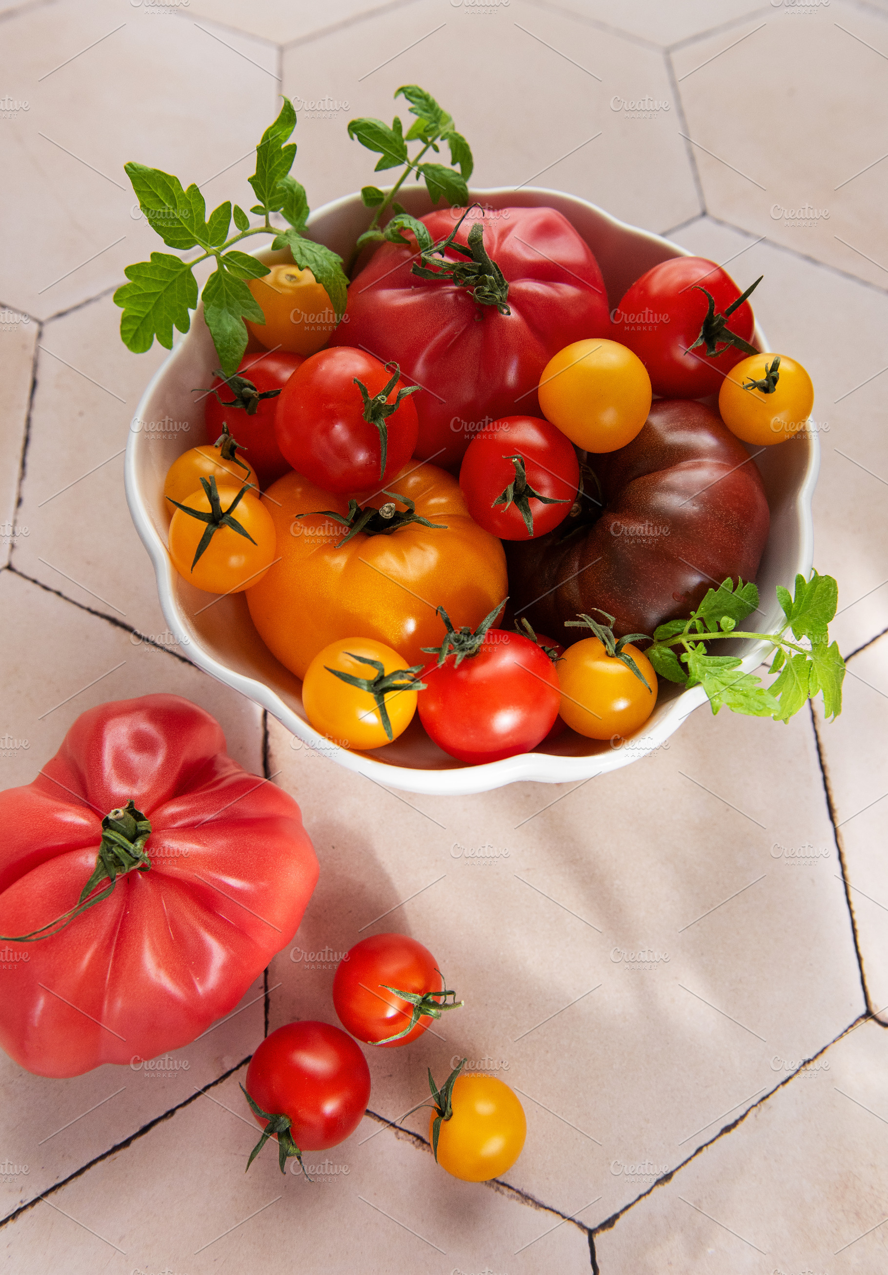 Fresh organic heirloom tomatoes in white bowl, a Food & Drink Photo by Olena Rudo