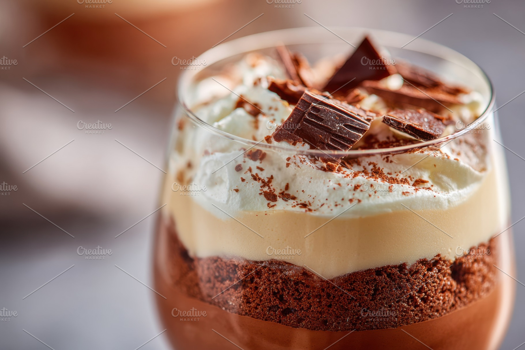 Sweet chocolate mousse with white cream and chocolate shavings, a Food & Drink Photo by AlyaAnd
