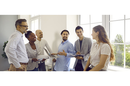 Group of office colleagues chatting, a Person Photo by StudioRomantic