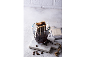 Freshly brewed drip coffee in glass, a Food & Drink Photo by Yulia Furman