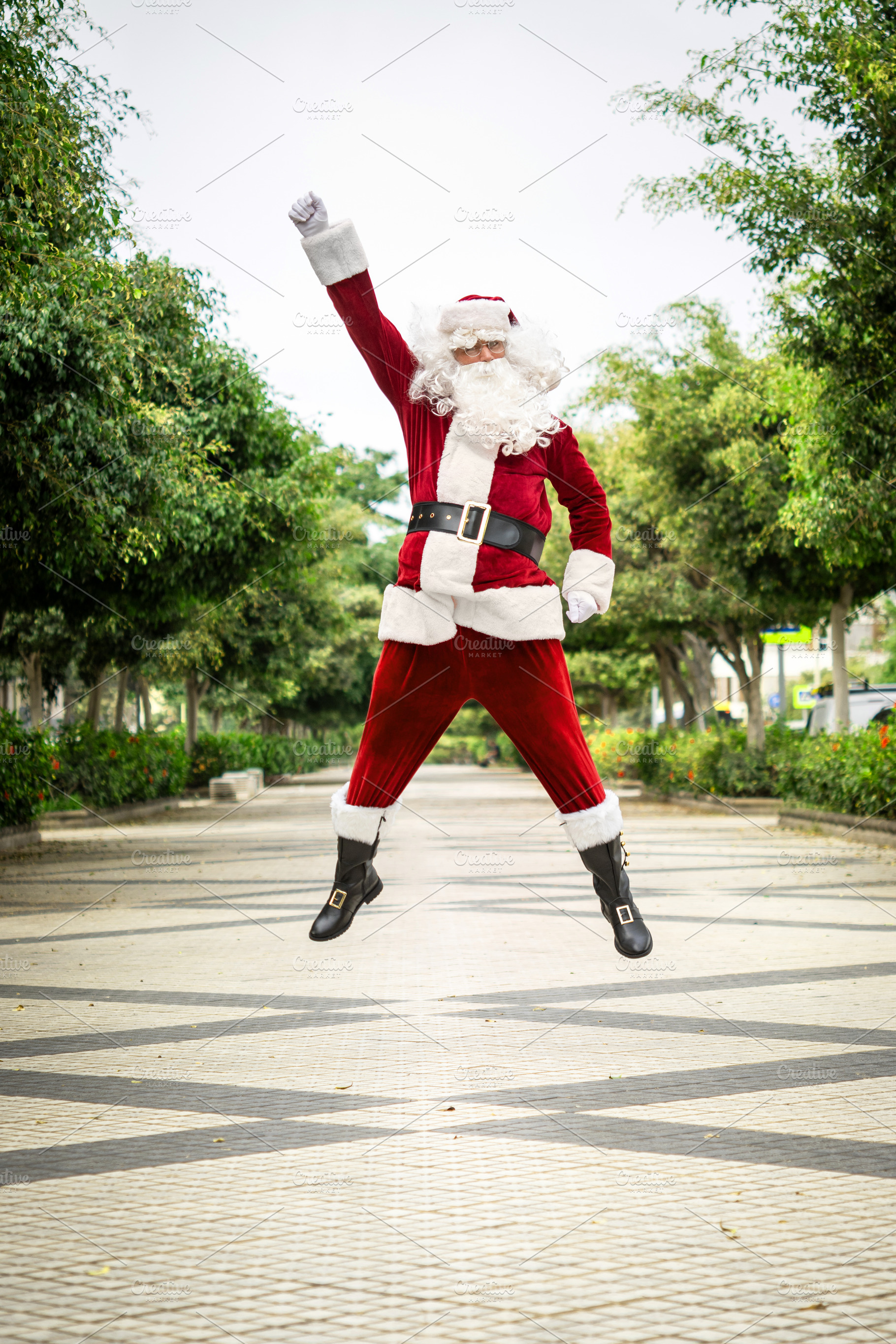 Santa Claus jumping in the air celebrating Christmas, a Person Photo by etorres69
