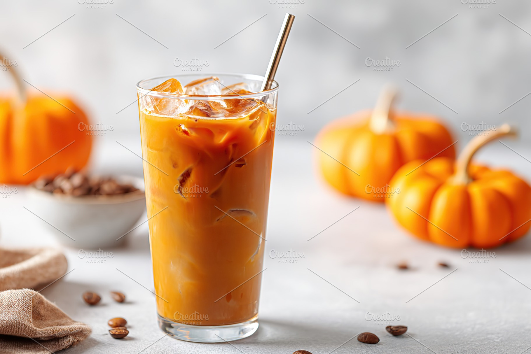Refreshing iced pumpkin spice beverage served with seasonal decorations, a Food & Drink Photo by AlyaAnd