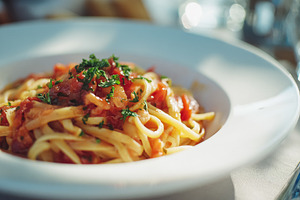 Linguine pasta dish with fresh tomato sauce and parsley, an auth, a Photo by Studio ANNA