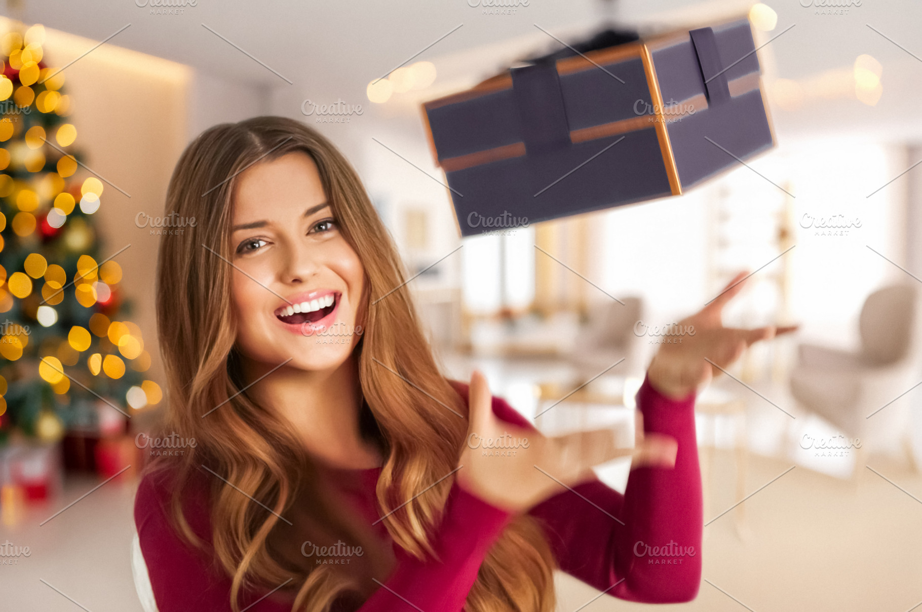 Happy woman catching a Christmas gift, celebrating holiday seaso, a Person Photo by Studio ANNA