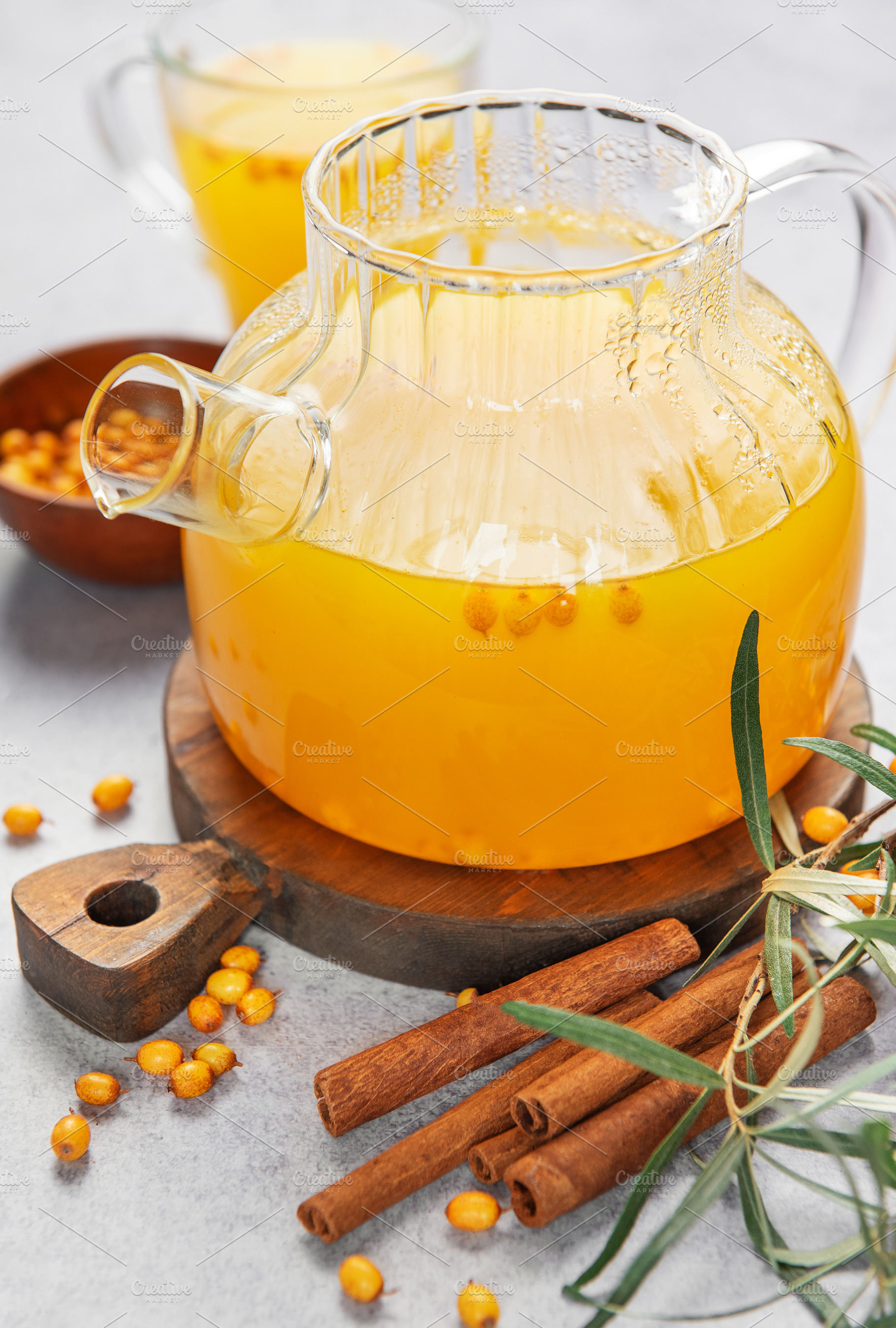 Sea buckthorn tea in teapot with cinnamon and berries, a Food & Drink Photo by Olena Rudo