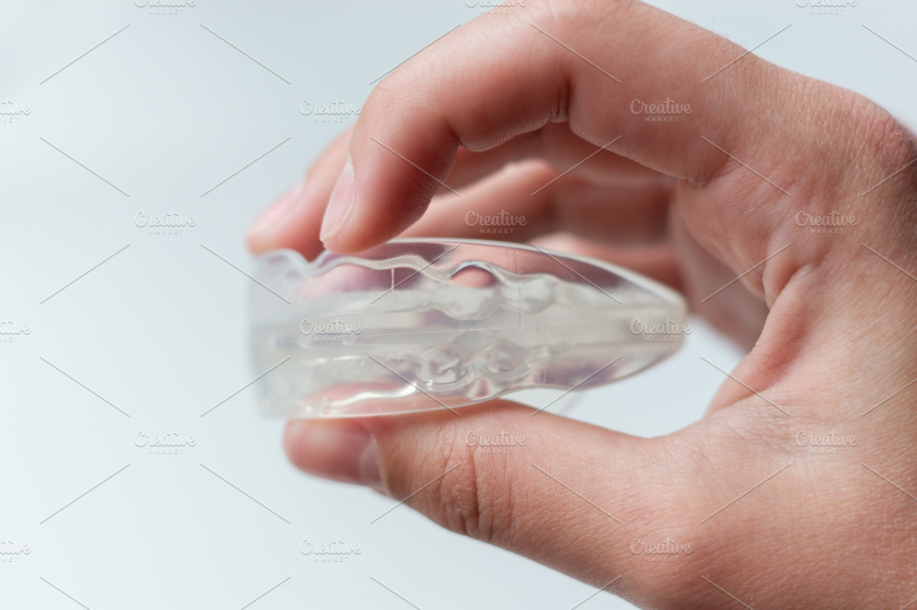 Holds a mouth guard in his hand, a Health & Medical Photo by Nastya_Velko