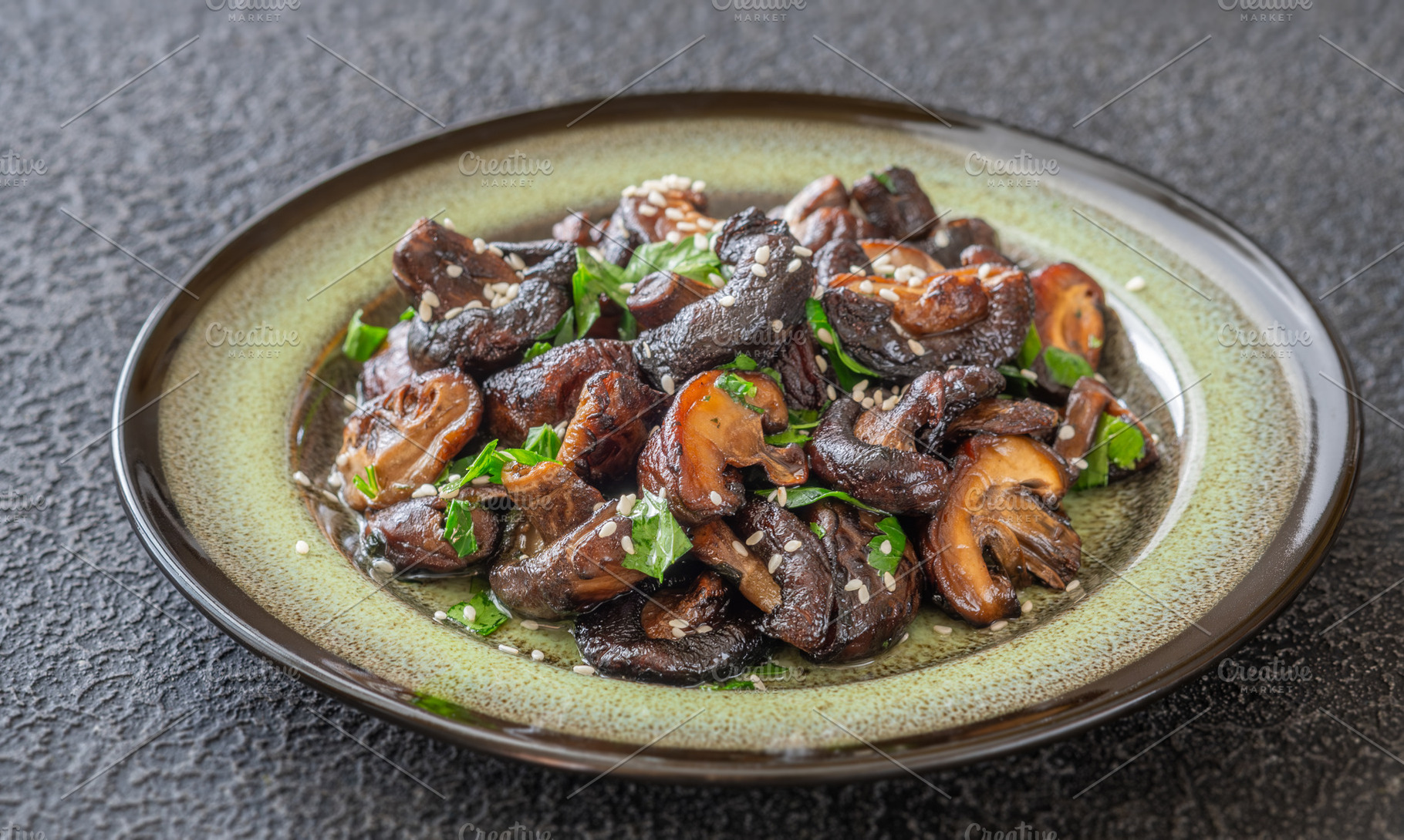 Pan fried shiitake mushrooms with sesame seeds on artisanal cera, a Food & Drink Photo by Alexander Prokopenko