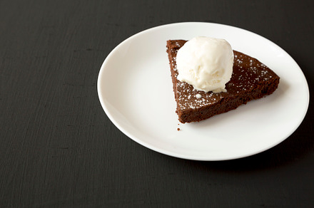 Homemade Chocolate Cake with Ice Cream on a black surface, side, a Food & Drink Photo by LiudmylaChuhunova