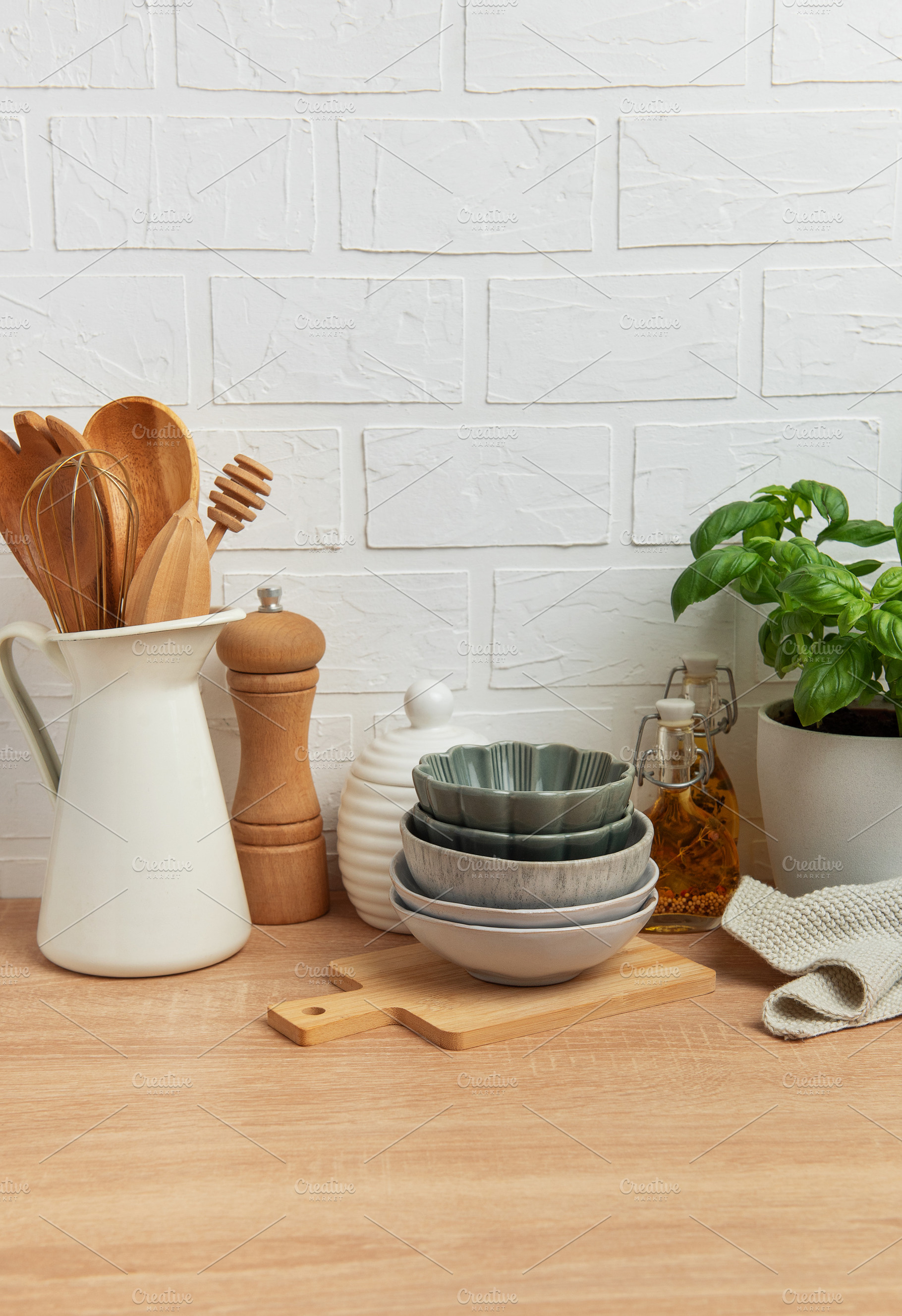 Kitchen utensils, bowls and spices resting on wooden countertop, a Photo by Olena Rudo