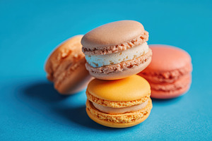 Colorful macarons on blue background, a Food & Drink Photo by AlyaAnd