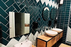 Modern bathroom interior with tiled walls and stylish sinks, a Photo by AS photostudio