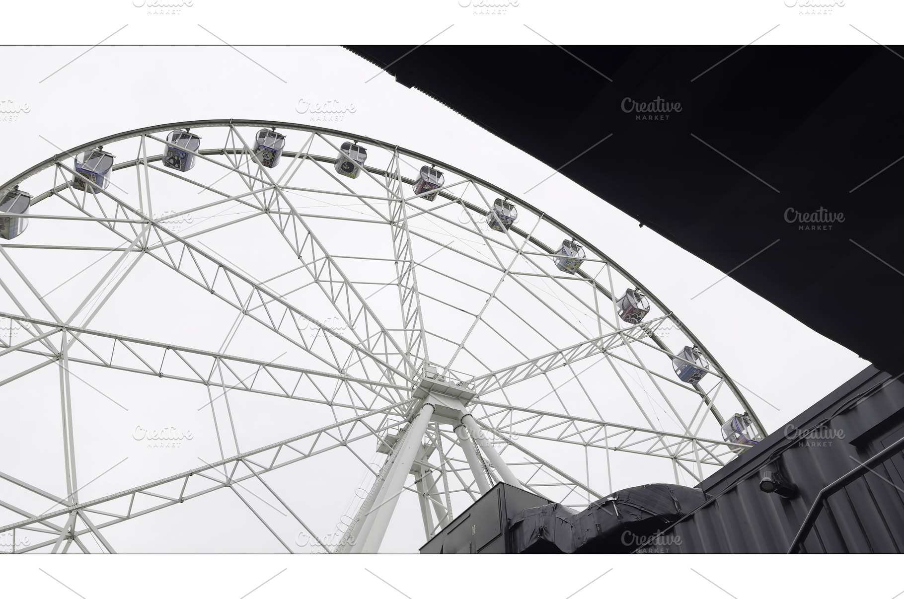 White ferris wheel slowly rotating, an Architecture Photo by Media Whale Stock
