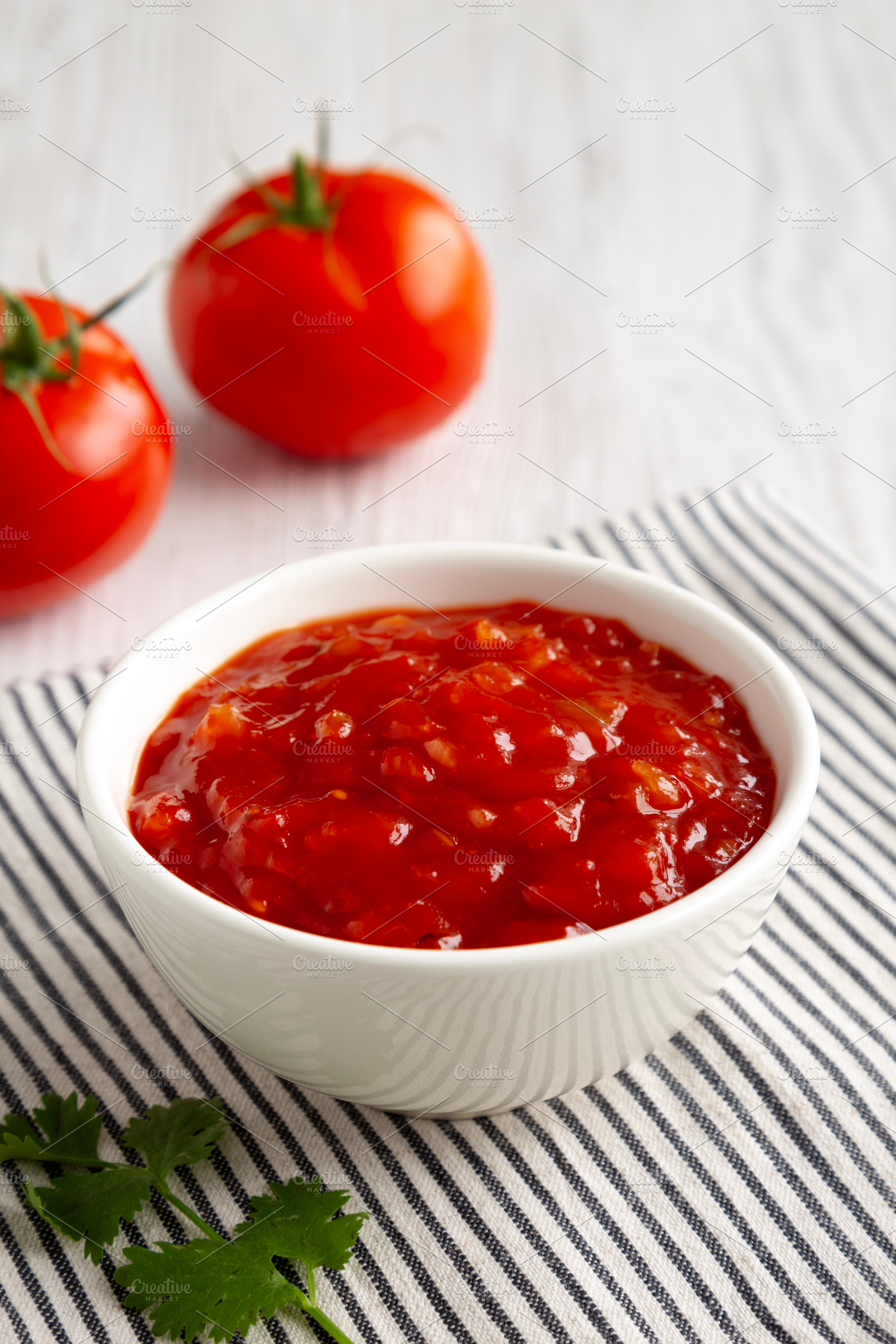 Organic Tomato and Cilantro Salsa in a Bowl, side view., a Food & Drink Photo by LiudmylaChuhunova