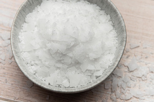 Magnesium flakes in a bowl on wooden table, a Health & Medical Photo by Olena Rudo