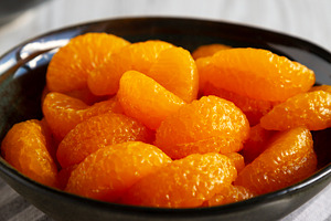Organic Canned Mandarin Oranges in Bowls, side view. Close-up., a Food & Drink Photo by LiudmylaChuhunova