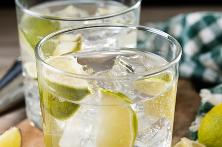 Glass of vodka tonic cocktail on wooden table, a Food & Drink Photo by etorres69
