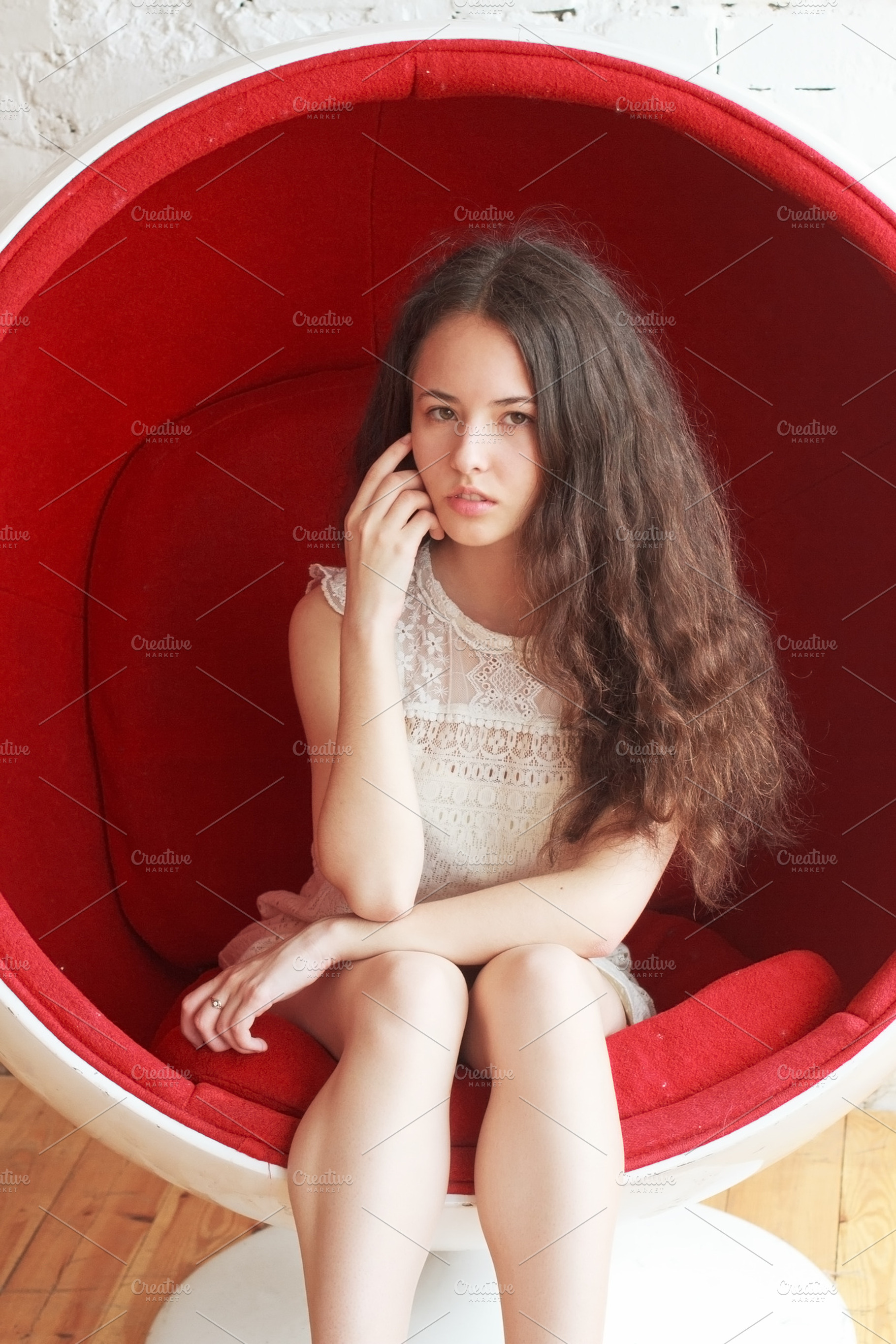 Woman Sitting In Red Chair