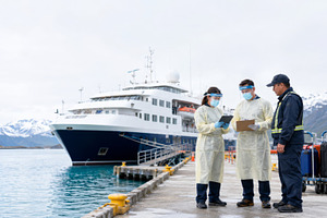 Healthcare workers on pier discussing procedures near cruise shi, a Photo by Dvoevnore photos