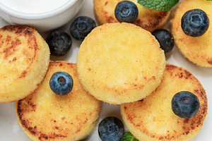 Cottage cheese pancakes with blueberries and sour cream, a Food & Drink Photo by Olena Rudo