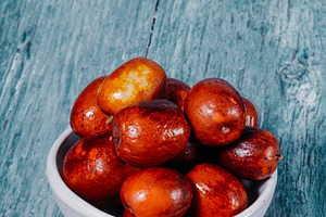 jujube fruits in a ceramic bowl, a Photo by Nito