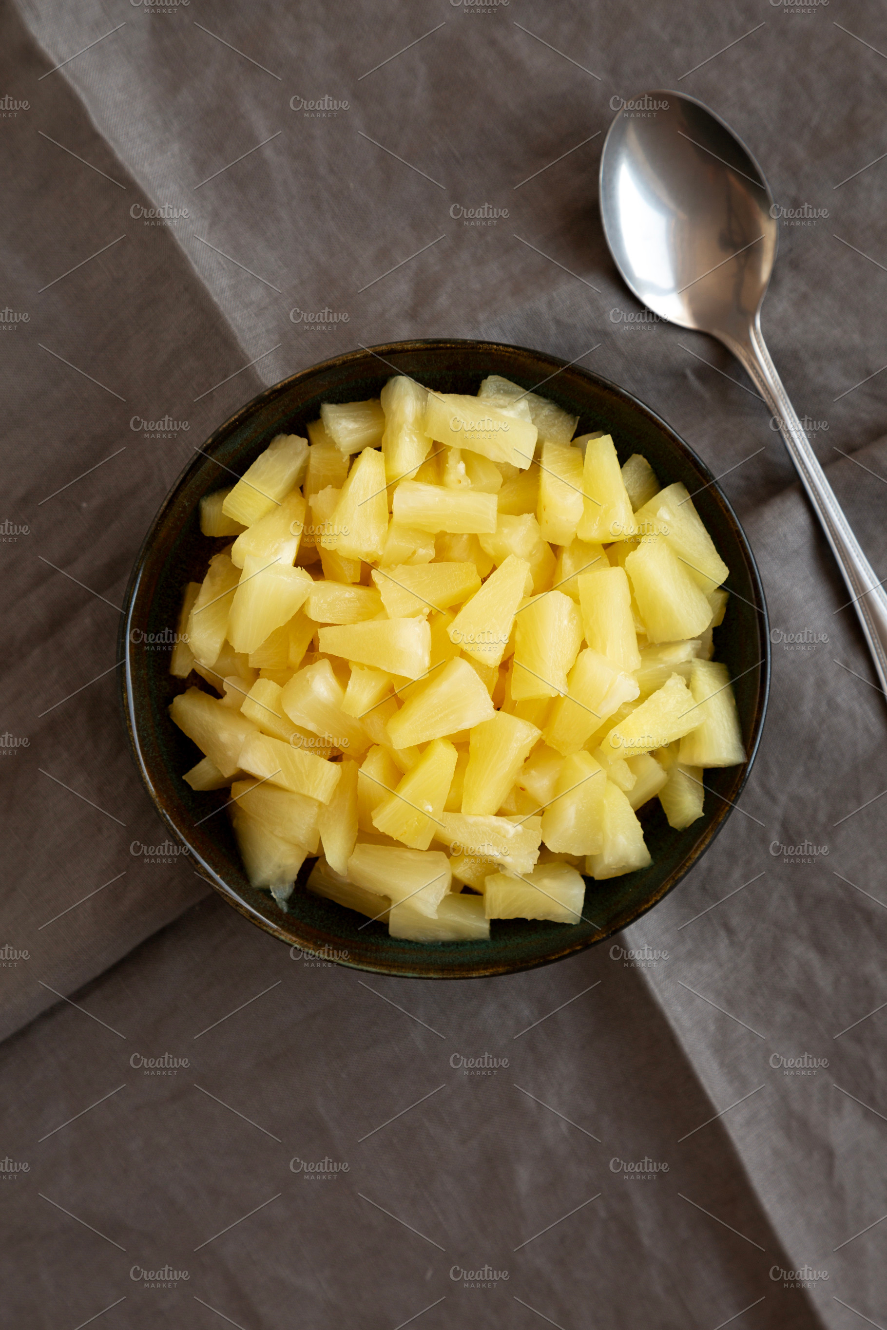 Canned Pineapple Tidbit Chunks in a Bowl, top view., a Food & Drink Photo by LiudmylaChuhunova