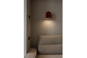 Cozy sofa corner with red wall light, an Architecture Photo by wip3out