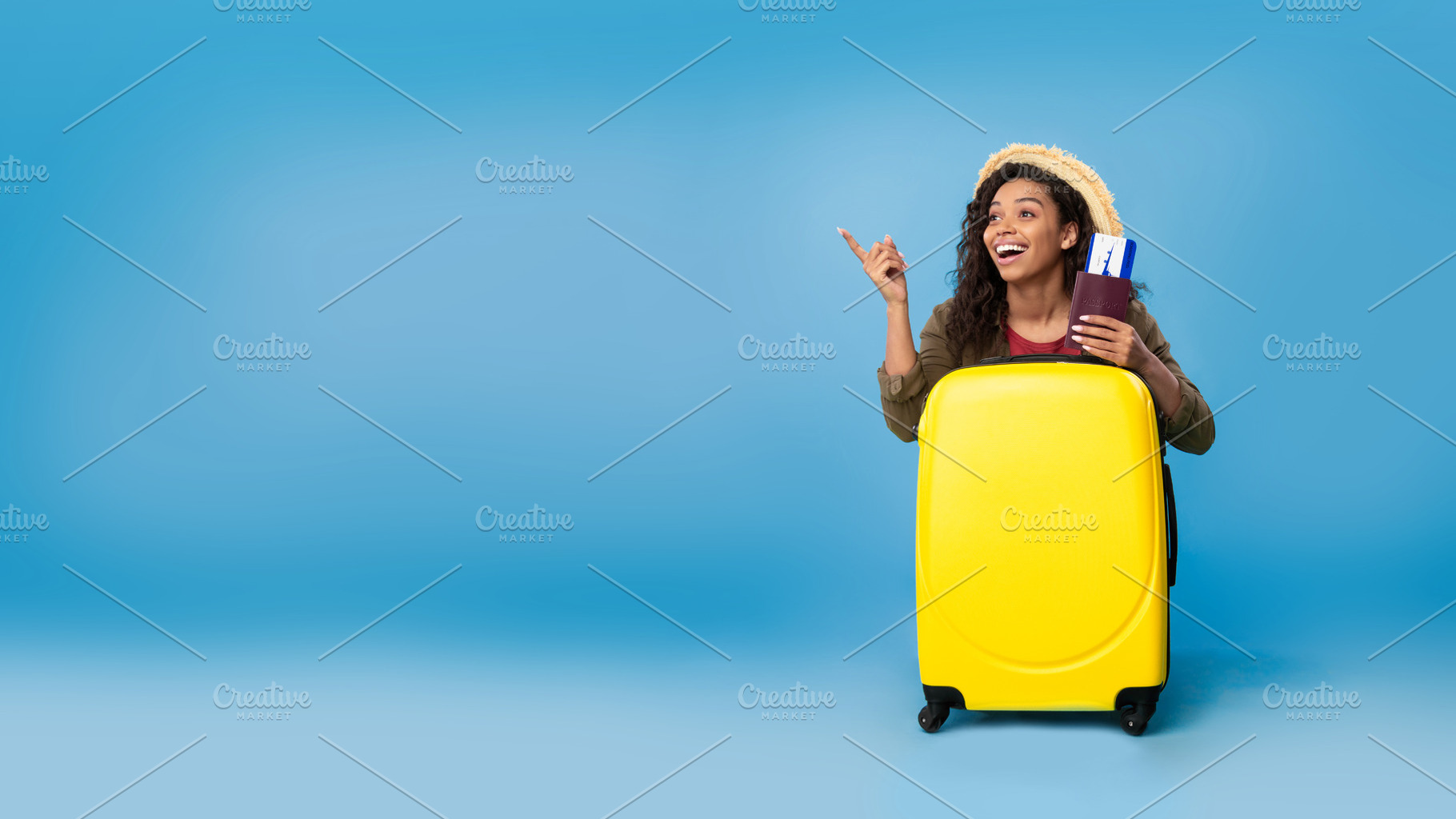 Carefree young black woman holding passport and tickets, sitting behind suitcas, a Photo by Prostock-Studio