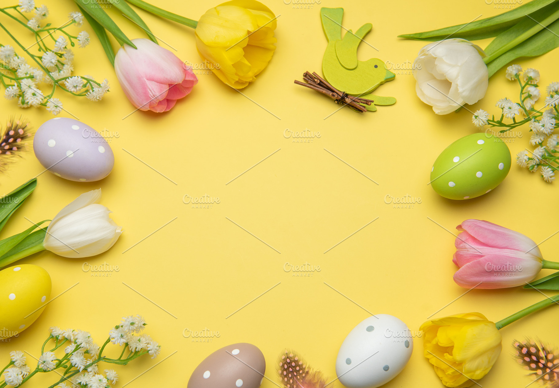 Easter eggs and tulips framing yellow background with wooden bir, a Holiday Photo by Olena Rudo