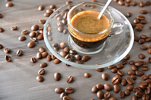 Coffee cup in glass and glass saucer on wooden table, a Food & Drink Photo by Davizro's Market