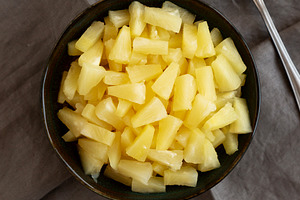 Canned Pineapple Tidbit Chunks in a Bowl, top view., a Food & Drink Photo by LiudmylaChuhunova