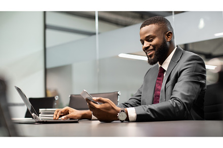 Handsome black businessman using, a Person Photo by Prostock-Studio