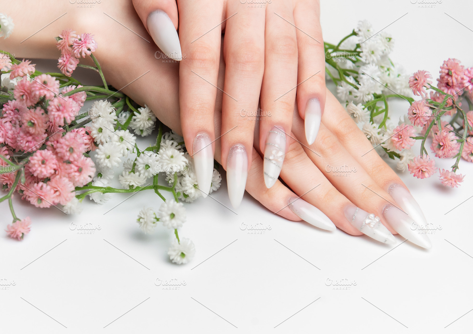 Woman showing hands with long white ombre nails, a Health & Medical Photo by Olena Rudo