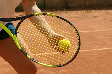 Woman hold racket and tennis ball on clay court, a Sports & Recreation Photo by AtlasStudio PRO