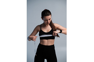 Young woman in sportswear measuring, a Sports & Recreation Photo by volodymyrshtun13795