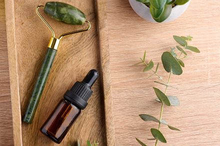 Brown glass bottle with pipette and green stone roller massager, a Beauty & Fashion Photo by ndanko
