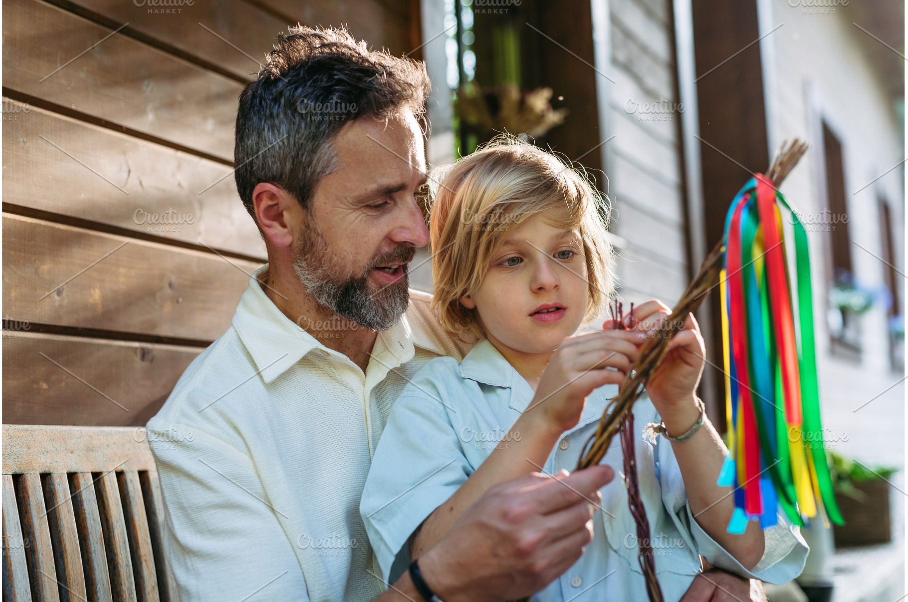 Father and boy braiding easter whip, a Holiday Photo by HalfPoint