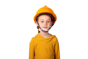 Young girl in yellow shirt and orange safety helmet standing aga, a Person Photo by Ales Munt