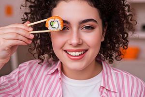 Young Woman Holding Sushi Roll with, a Food & Drink Photo by Stock Shape