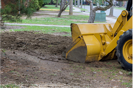 Small tractor digging land working, an Industrial Photo by Ungvar Studio